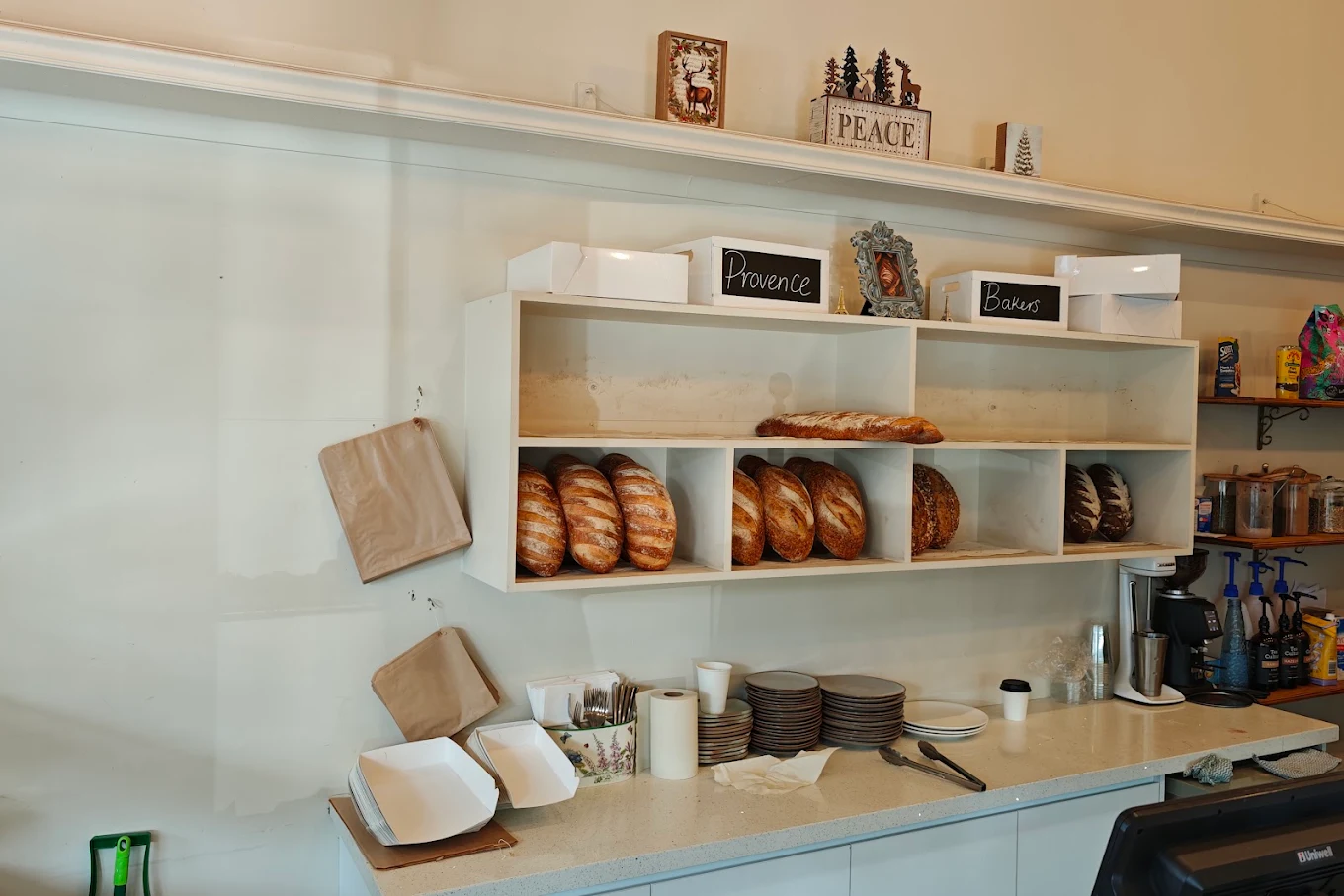 Timber shelves of freshly baked pastries behind the Provence Bakers counter