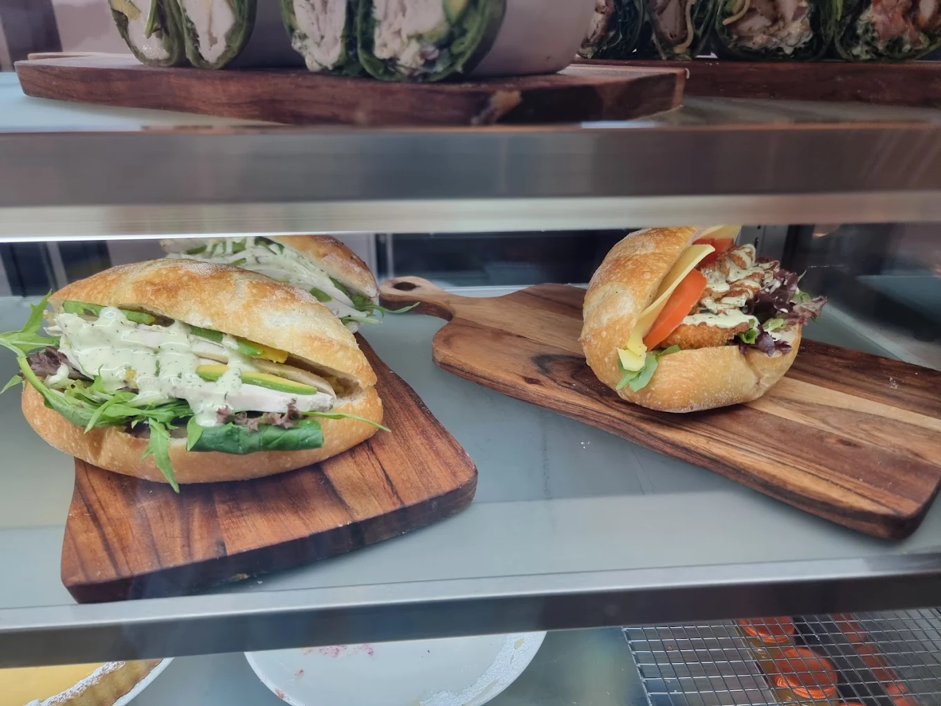 Fresh sandwiches and rolls arranged on timber boards