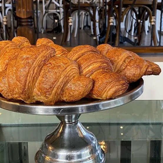Croissants stacked on a timber stand