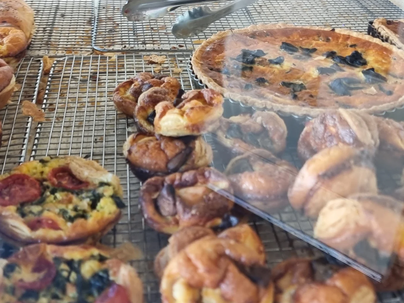 Quiche and pastries cooling on a wire rack