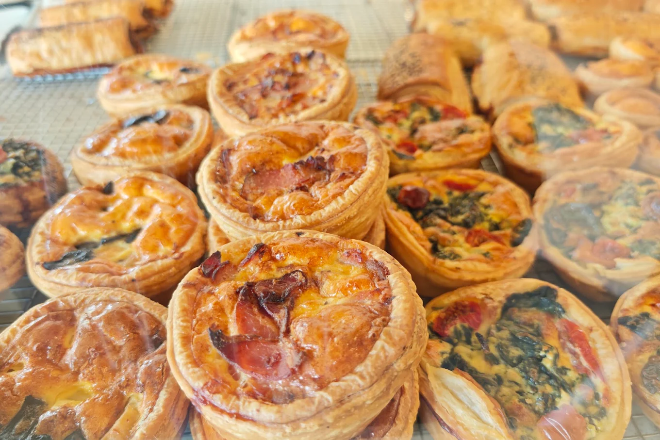 Tray of freshly baked quiches at Provence Bakers