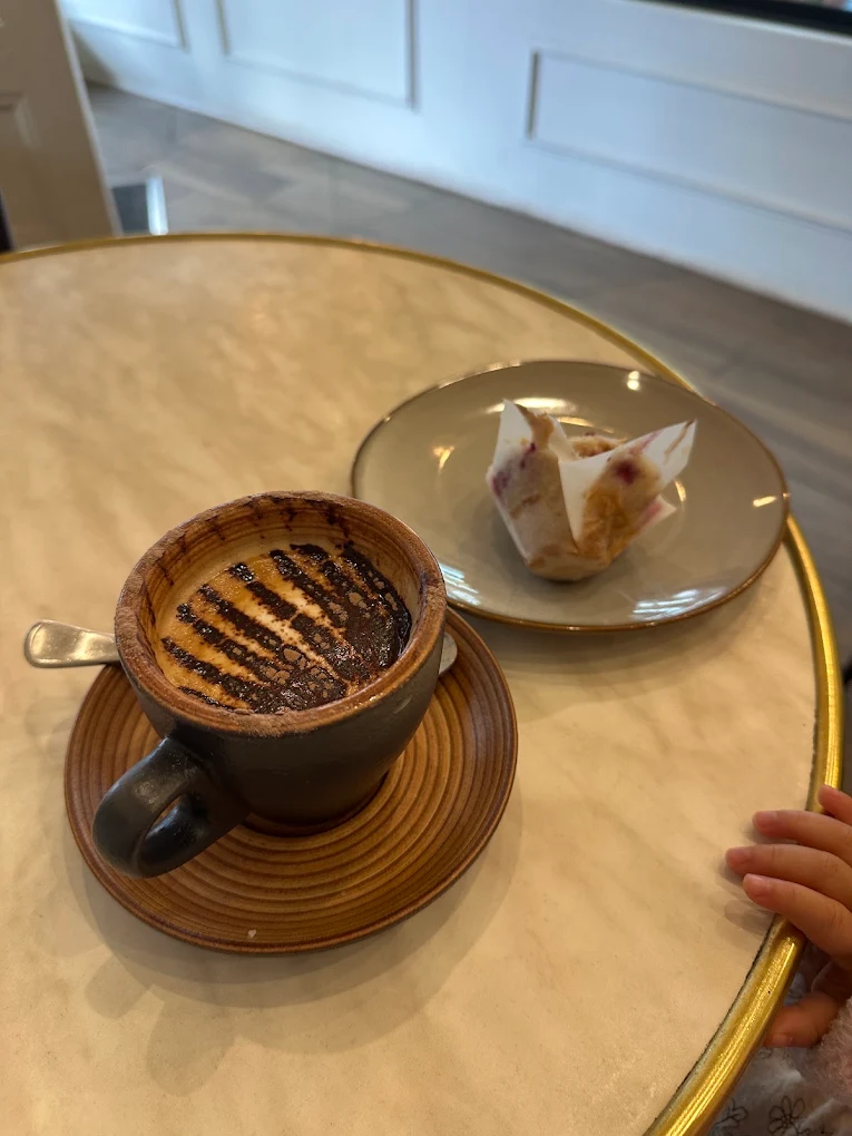 Coffee and a pastry on a cafe table